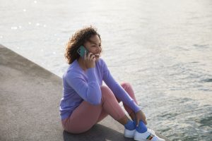 Woman speaking on the phone next to the sea