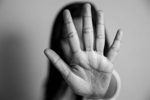 Woman raised her hand to campaign against stopping violence against women.