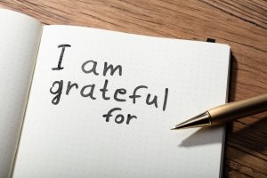 an open journal reads "I am grateful for"