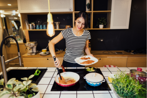 young woman cooks on induction stove top