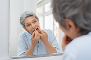 mature white woman flossing