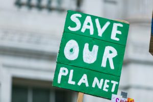 People with banners protest as part of a climate change march.