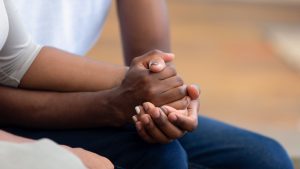 Two people holding hands as an empathy concept.