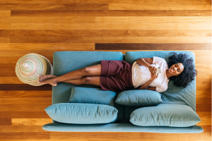 beautiful Black woman rests peacefully on the couch