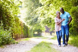 Older African American couple walking in the countryside.