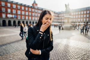 young woman feeling jet lagged yawns while sight seeing