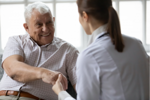 Doctor delivering good news to happy elderly patient