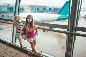 Children wearing masks in the airport