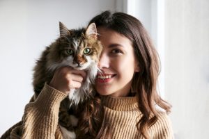 Woman holding her long-haired cat