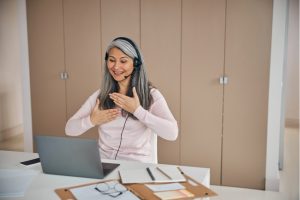 Mature Asian woman learns languge using gestures online