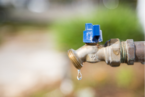 Drop dripping out of water tap outside