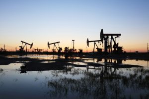 oil wells against a sunset