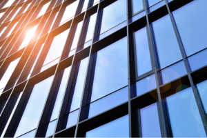 Reflection of sun in glass facade of high-rise building