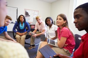 Teens sit in circle during class discussion