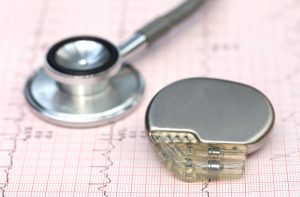 Close up of electrocardiograph with stethoscope and pacemaker.