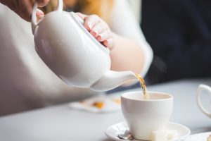 Pouring tea from a teapot