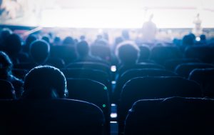 Group of people watching a movie in a theater