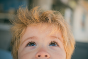 Child eyes closeup. Beautiful baby looking up