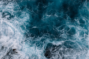 Ocean waves breaking into cliff